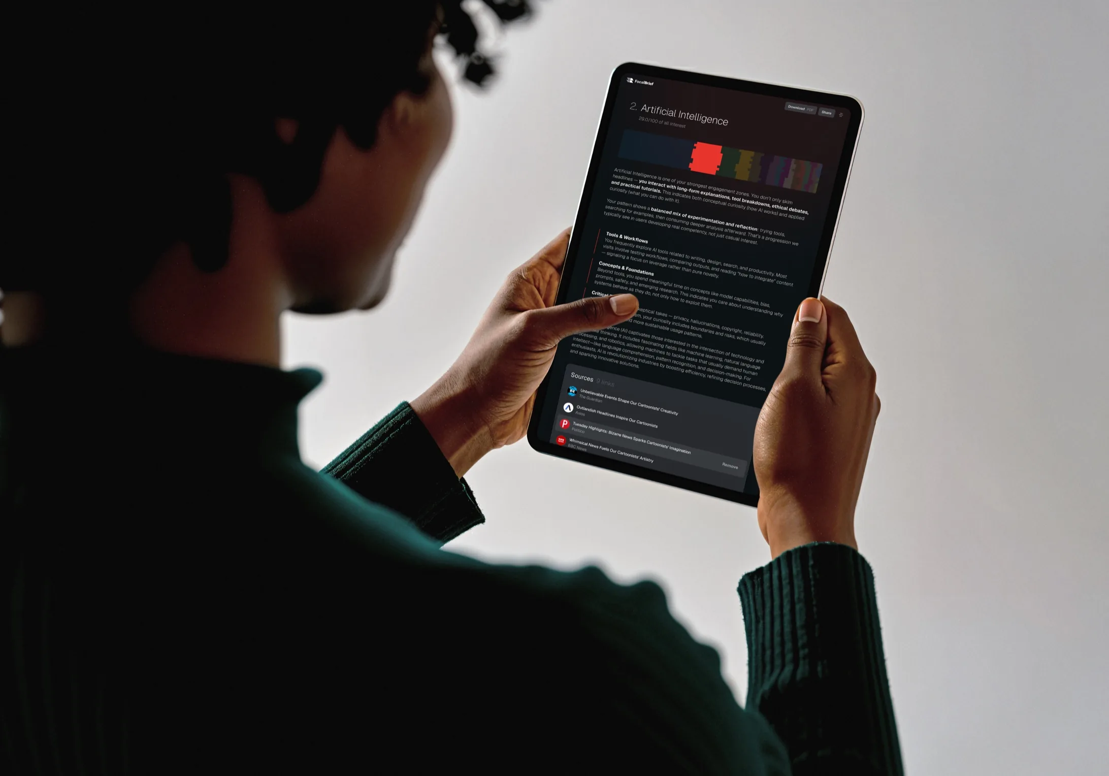 A person reading their FocalBrief interest report on a tablet